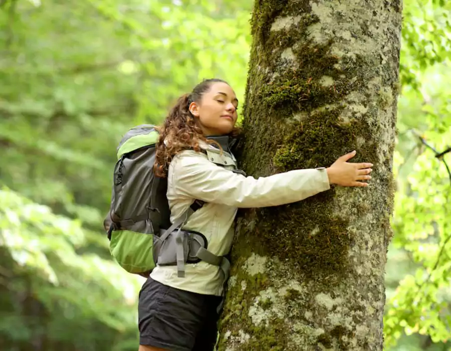 trekker_embracing_a_tree_in_the_forest